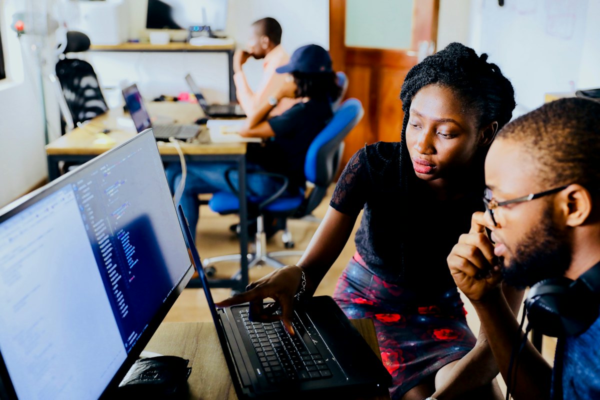 Colleagues collaborating at computers in an open office