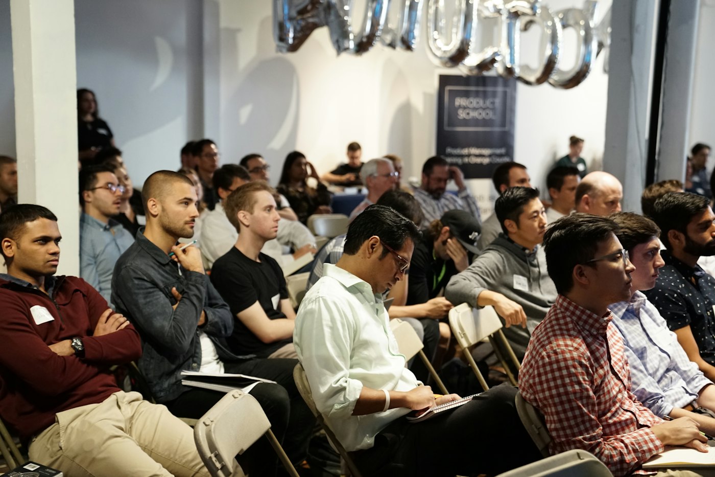 An audience attending a seminar in a studio space