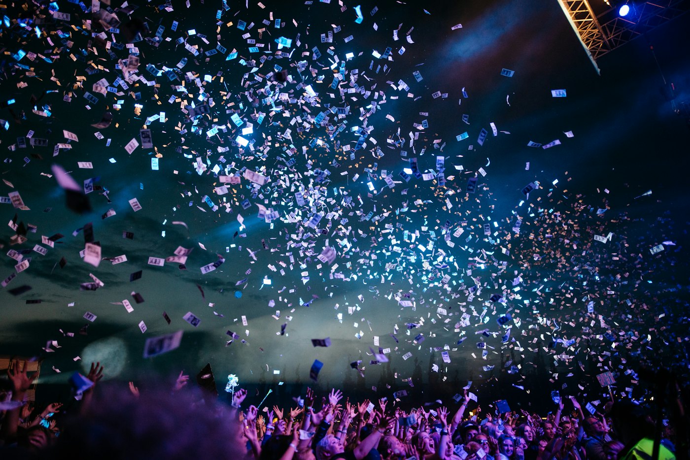 Confetti bursting over a crowd at a live show