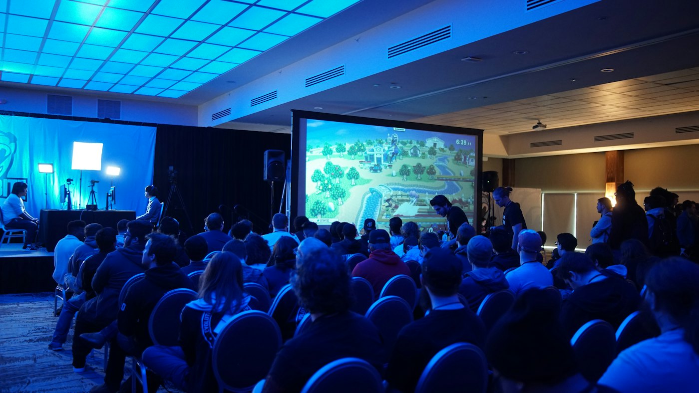 An audience watching a large screen at a screening event